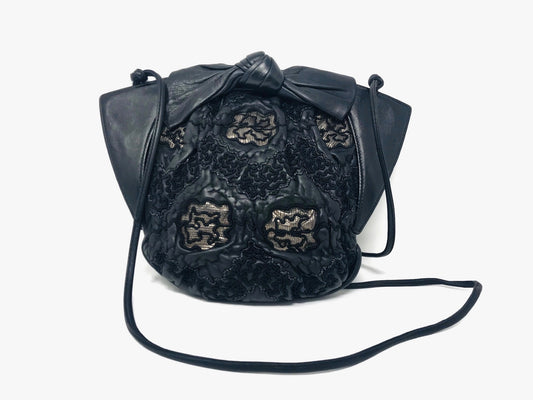 1980s black lambskin crossbody with lacework detail and bow accent